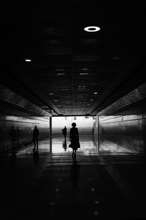 Free A person walking through an empty tunnel Stock Photo