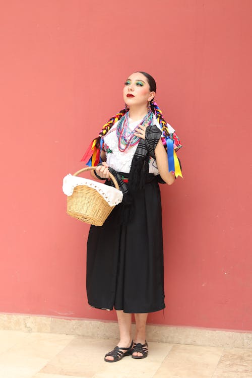 A woman in a skirt and a basket on her head