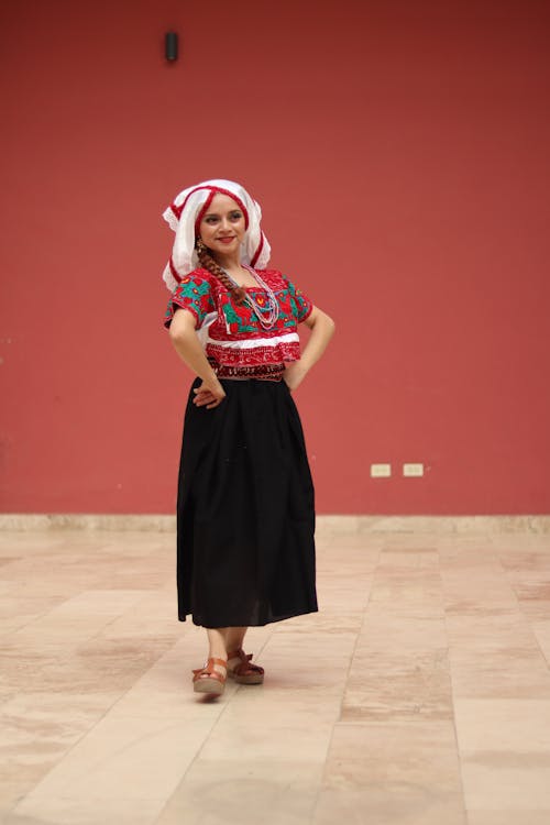 Free A woman in a traditional mexican dress poses for a photo Stock Photo