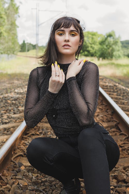 Woman Crouching On Train Track