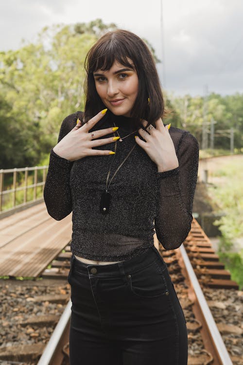 Woman Standing On Train Tracks