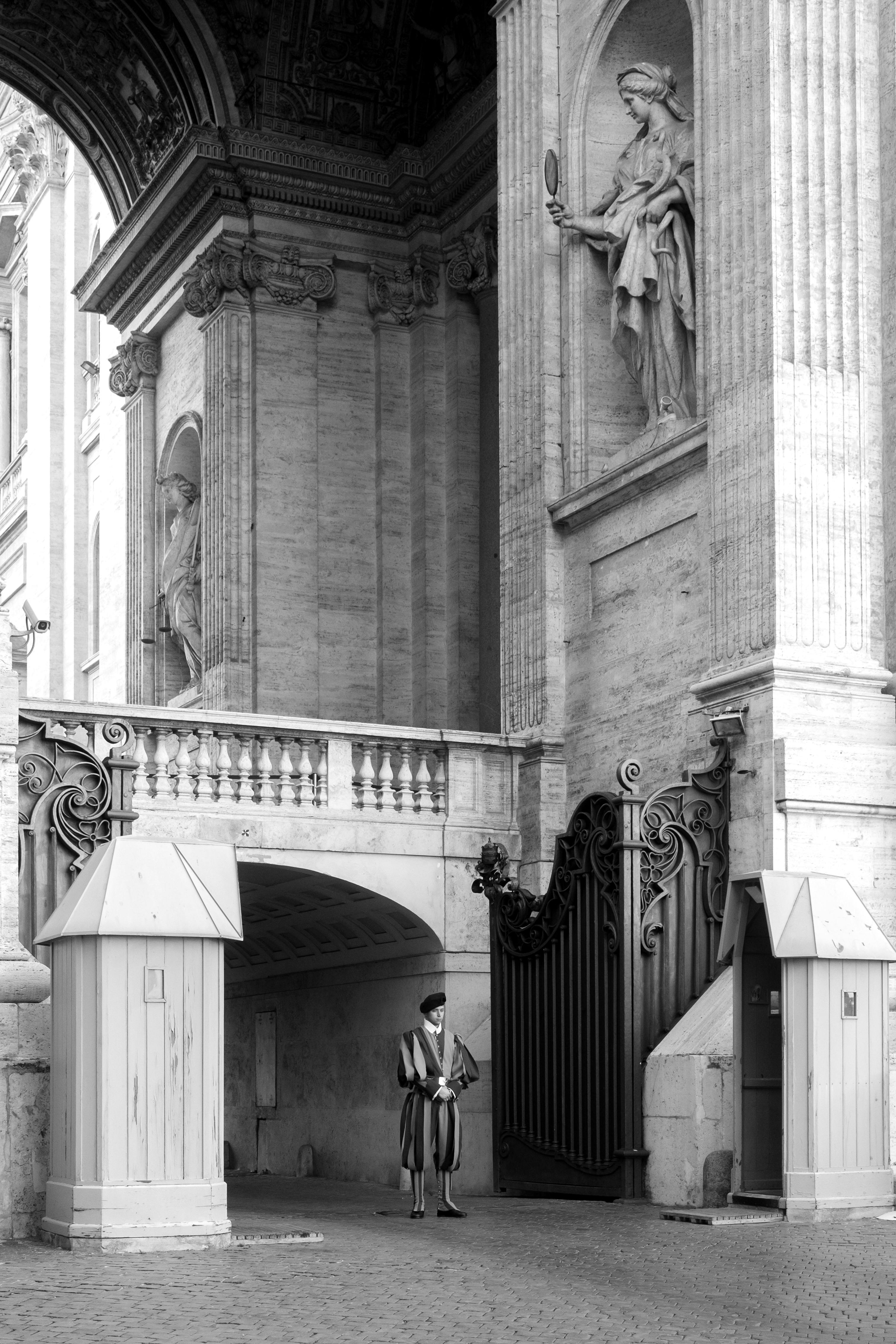 pontifical swiss guard at the gate of the papal basilica of saint peter