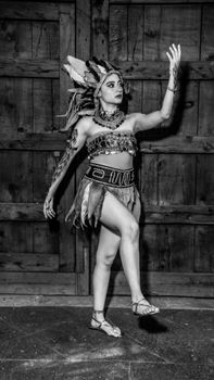 Elegant portrayal of a woman in traditional attire performing a dance, captured in black and white.
