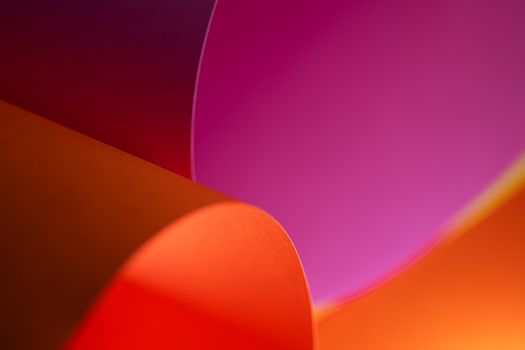 Vibrant close-up of overlapping orange and pink abstract shapes, creating dynamic visual interest.