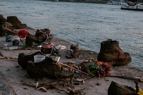 A river with shoes and flowers on the shore