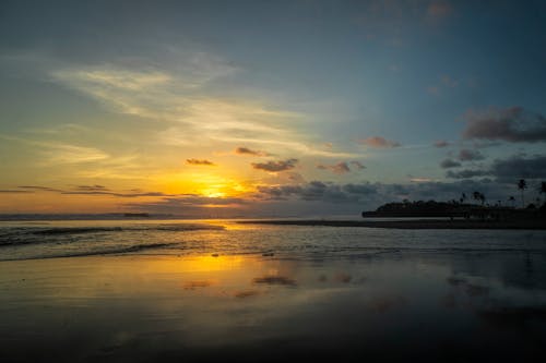 Calm Body Of Water During Golden Hour