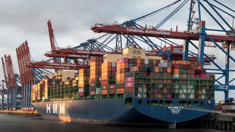 Crane loading a shipping container
