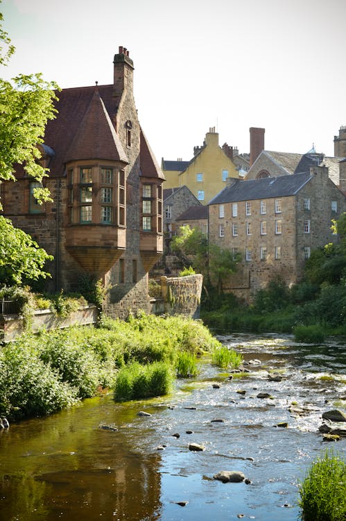 Free A river runs through a city with old buildings Stock Photo