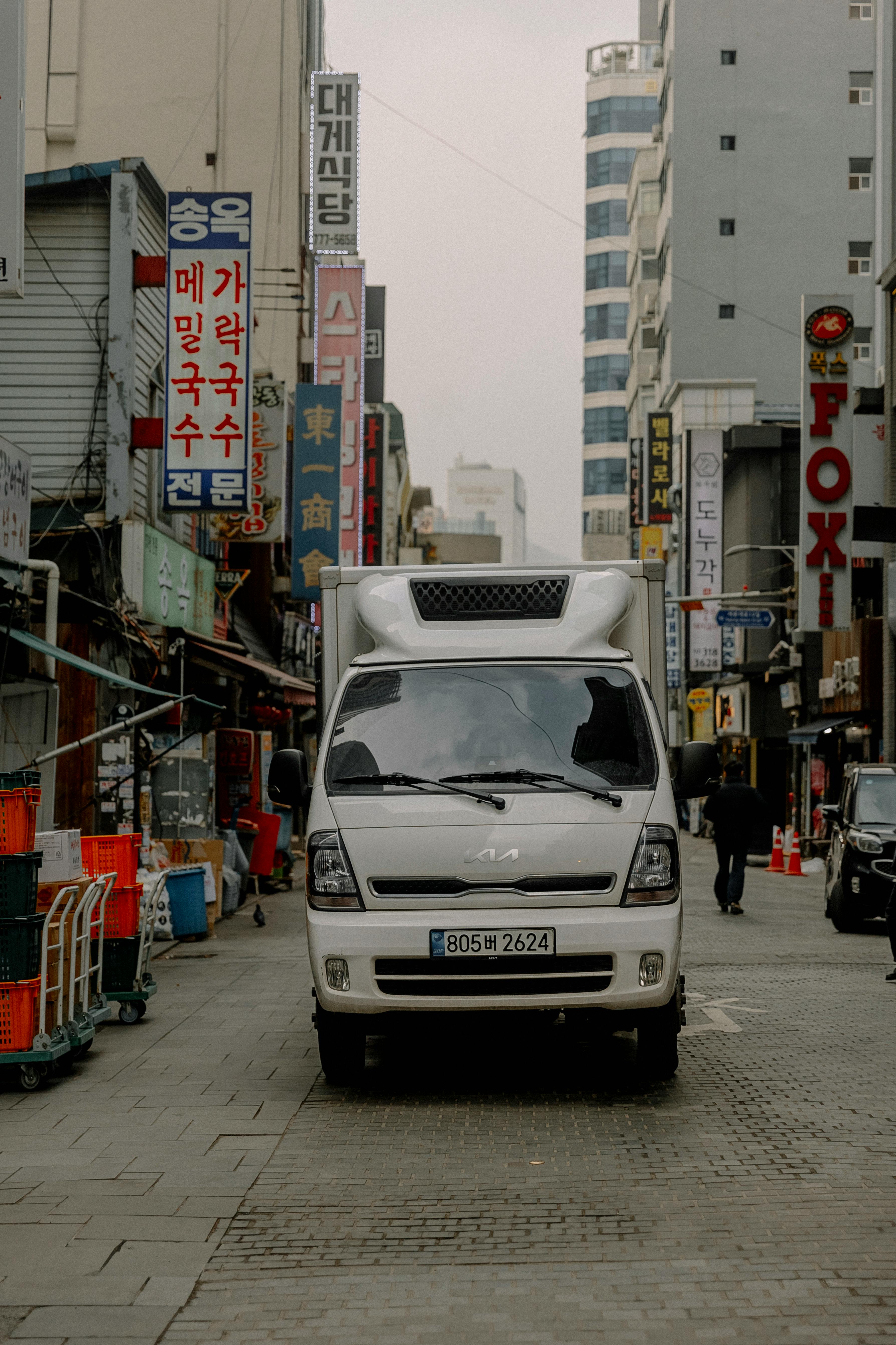 white kia bongo van in a korean city