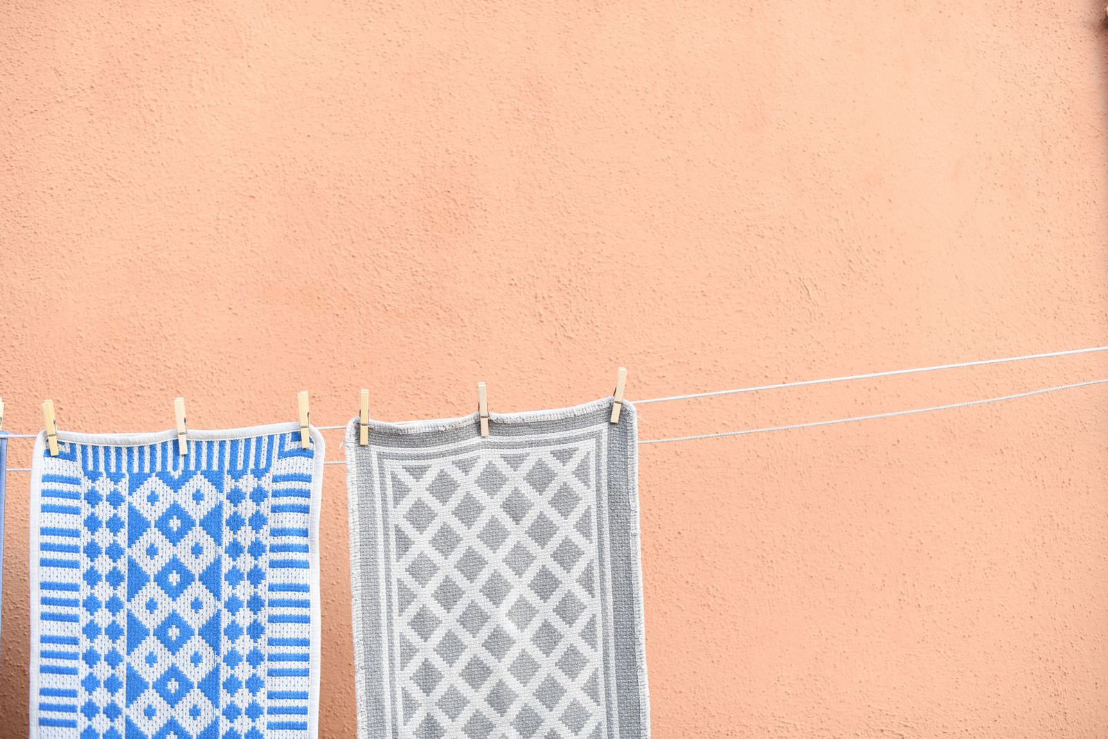 Rugs drying on a clothesline outdoors