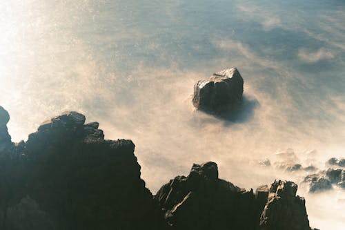 A photo of a rocky shore with fog