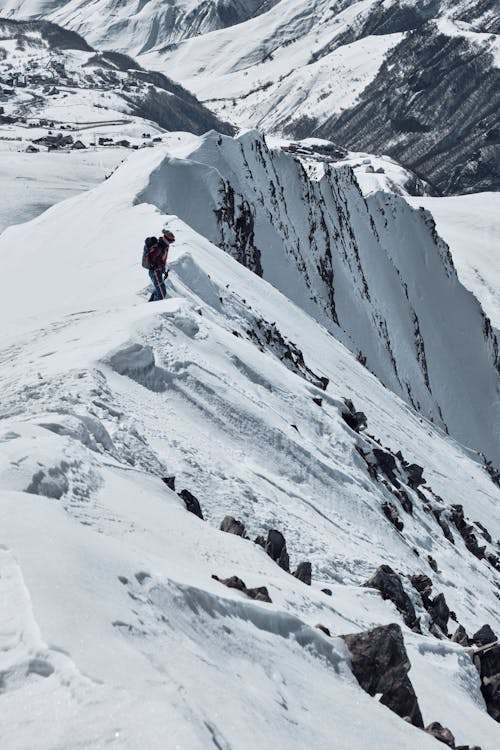 A person walking up a snowy mountain