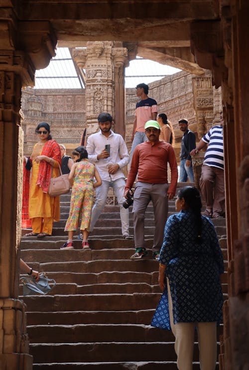 People walking up stairs in a temple