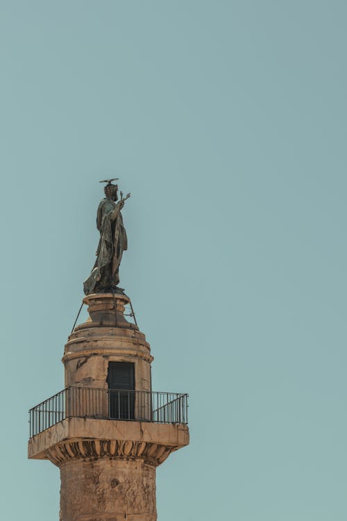 A statue on top of a tall building