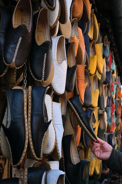 A person is looking at a wall of shoes