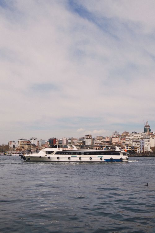 Free A ferry navigates the waters with Istanbul's iconic skyline in the background, showcasing urban charm. Stock Photo