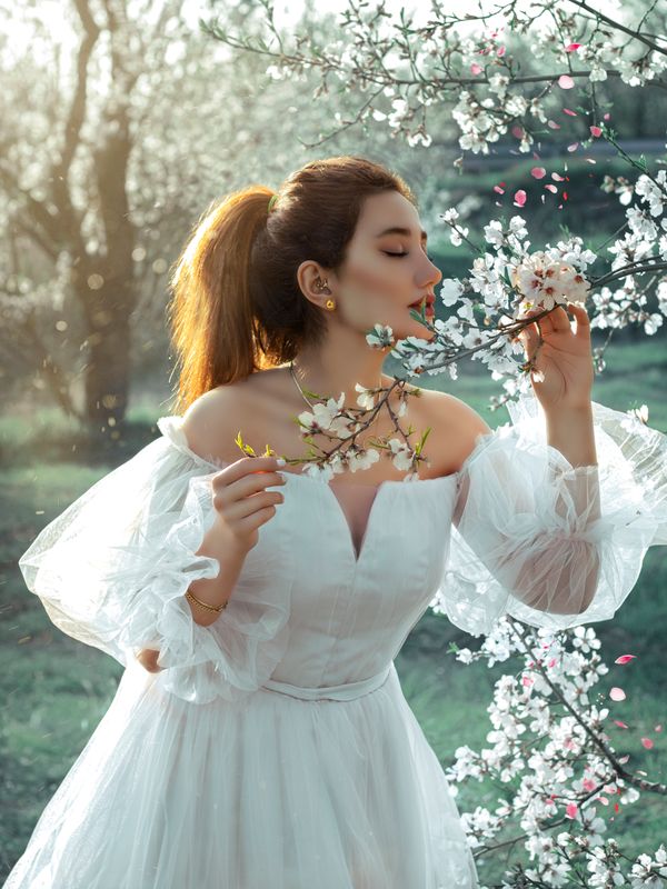 Woman wearing a white eyelet sundress in spring