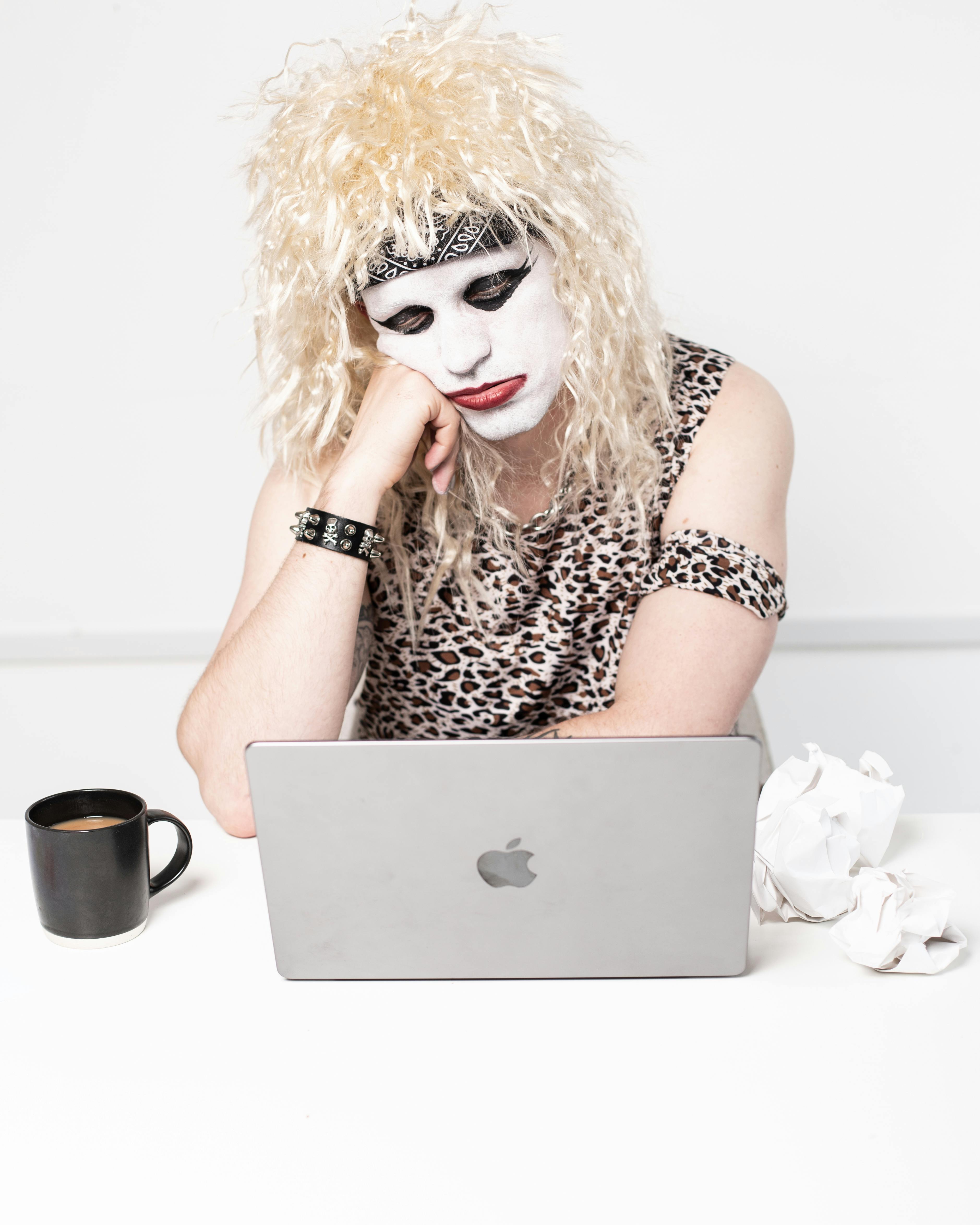 man in costume sitting and thinking over laptop
