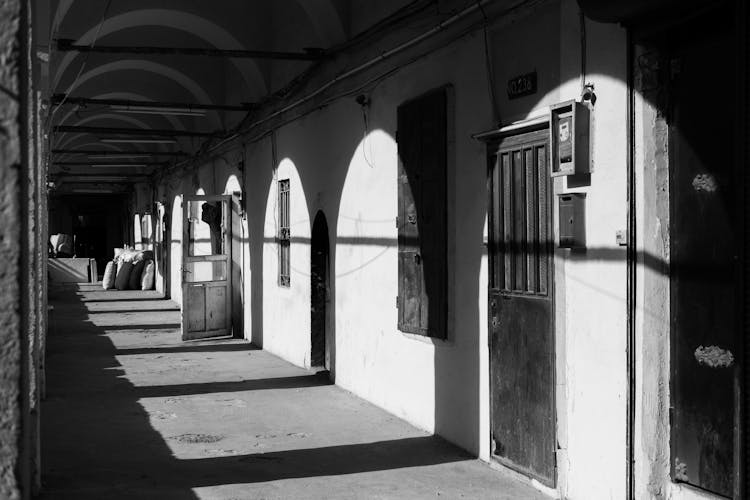 Black And White Photo Of An Alleyway With Arches