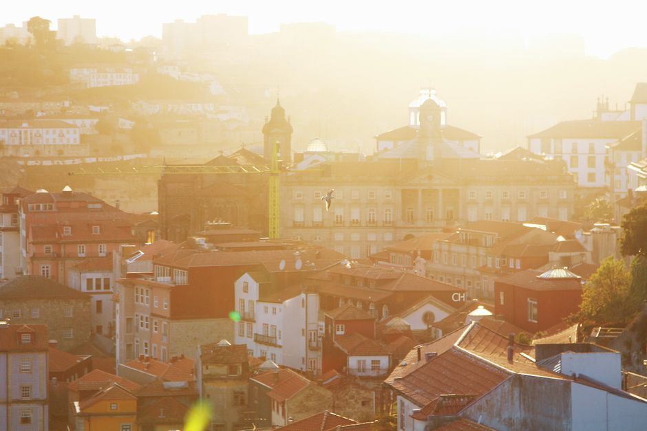 Captivating sunset view of Porto's historic rooftops, highlighting beautiful architecture and warm light.