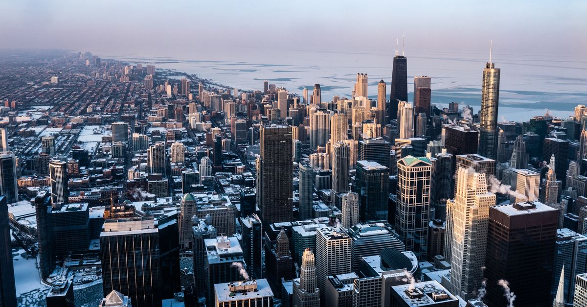 Stunning aerial view of Chicago's skyline with skyscrapers and the city covered in snow.
