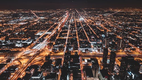 Free Aerial Photography Of City Buildings With Lights Turned On At Night Stock Photo