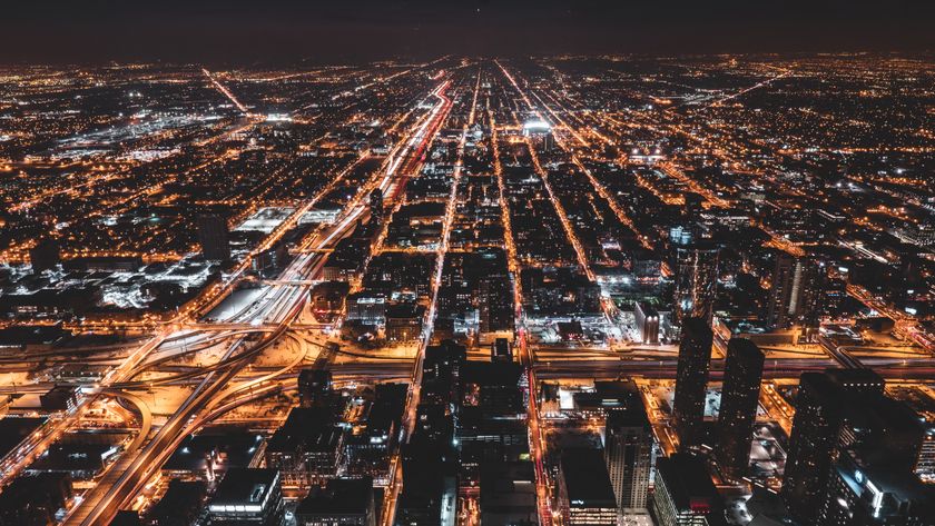 Aerial view of an illuminated city street grid at night — photo by Chait Goli on Pexels