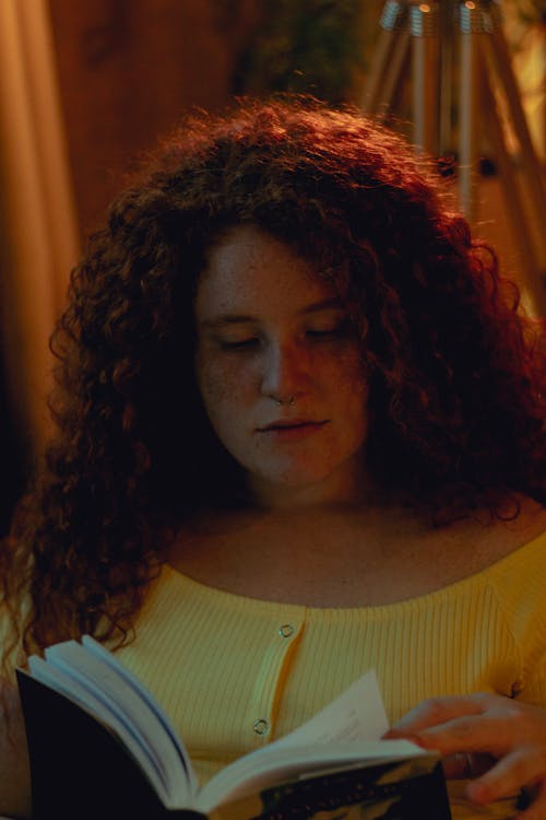 Woman Reading Book Inside Room