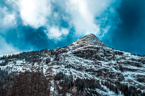 Free Captivating view of a snow-capped mountain peak in France, set beneath a dynamic sky. Stock Photo
