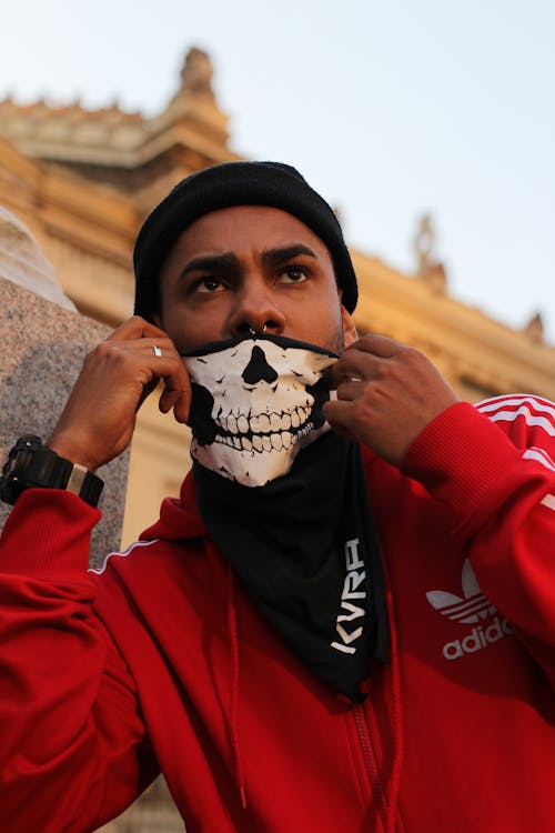 Man Covering His Face With Skull Mask