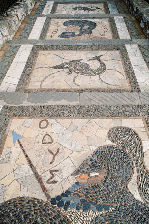 A mosaic floor with a bird and a horse