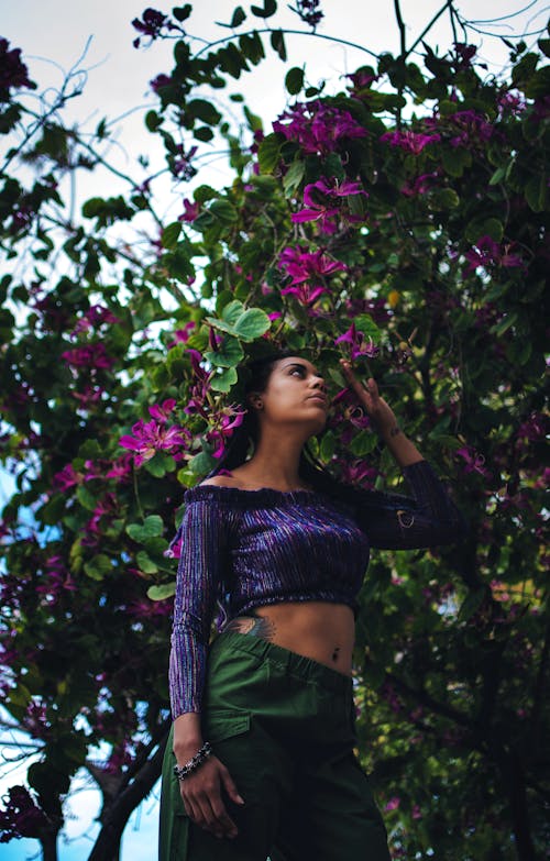 Woman Holding Purple-Petaled Flowers