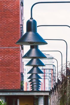 Stylish black street lamps aligned against a brick building in Victoria, BC, Canada.