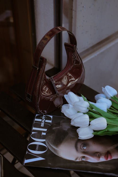 A magazine with a magazine and a purse on a table