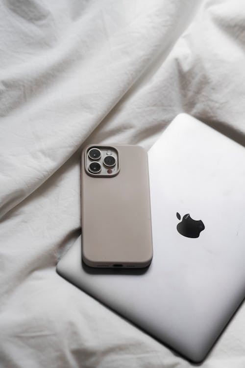 Free A white iphone 11 pro and a black apple watch Stock Photo