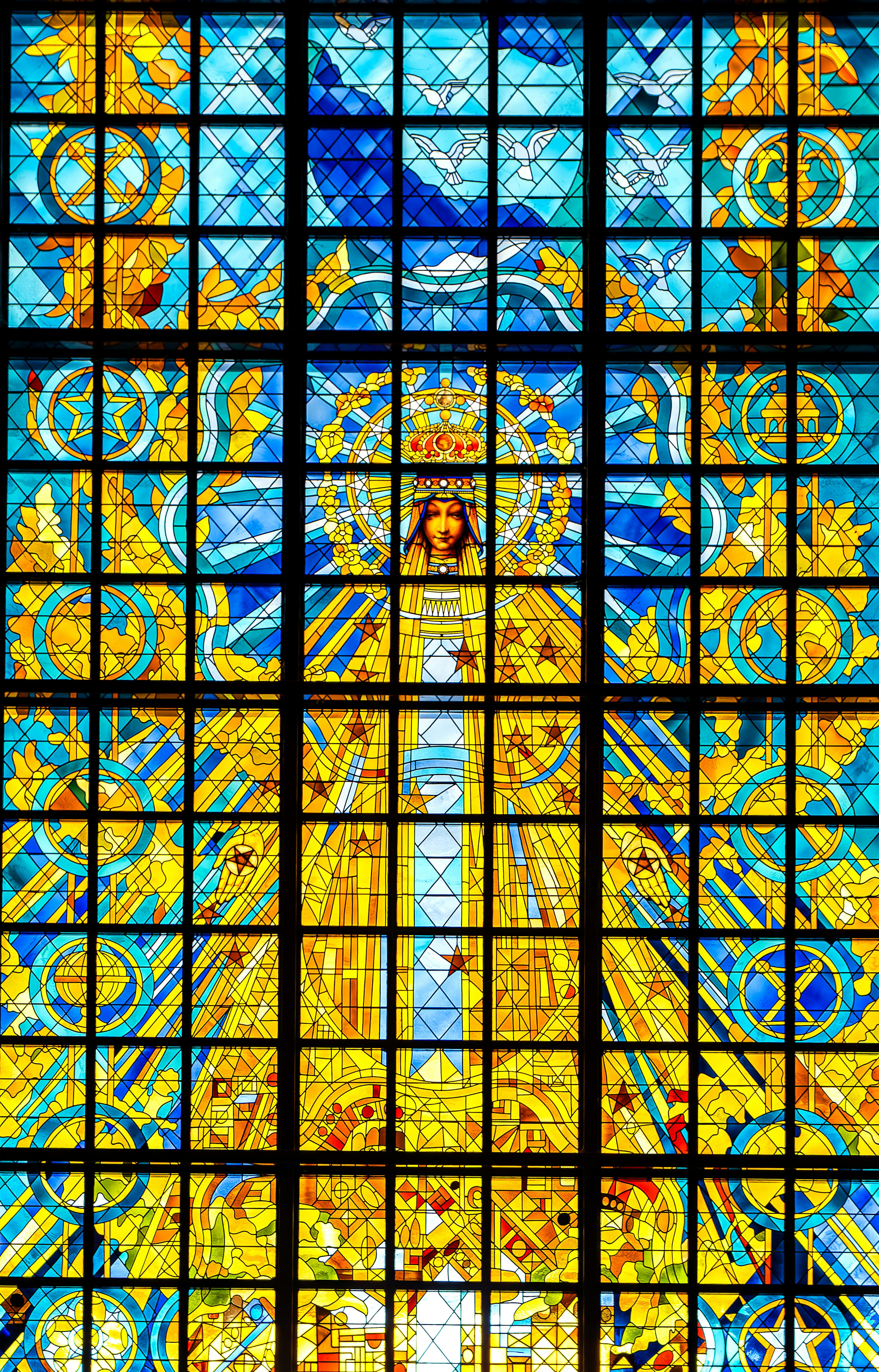 Vibrant stained glass in Basilica of Our Lady of Peace in Yamoussoukro, showcasing religious artistry.