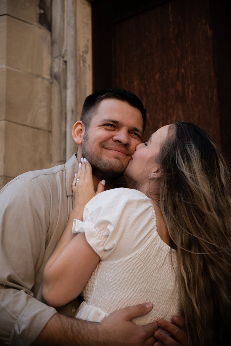 Woman Kissing Mans Cheek