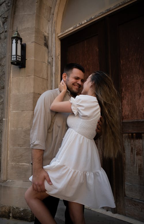 Free A couple is hugging in front of a door Stock Photo