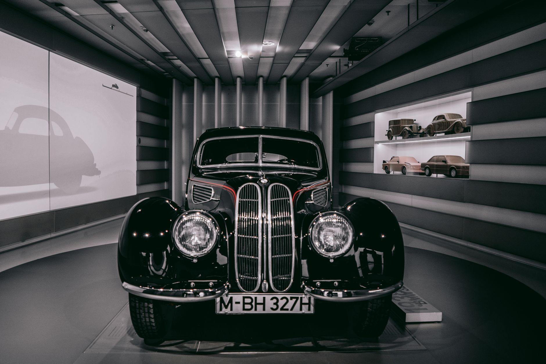 Vintage BMW car showcased in a Munich museum, highlighting automotive design history.