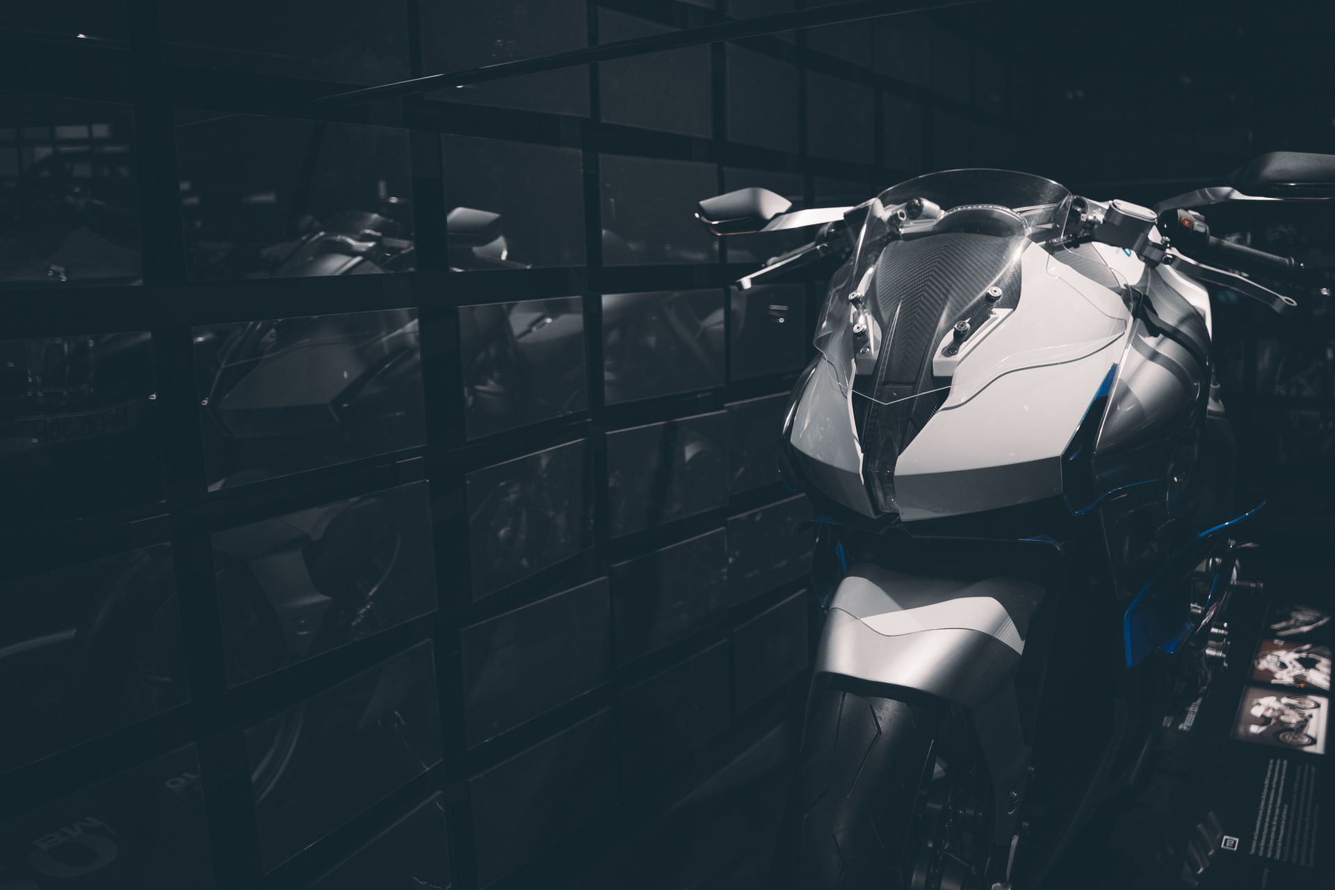 Sleek sports motorcycle showcased indoors with reflective surfaces