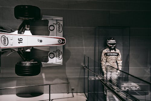 F1 Driver Statue Beside F1 Car