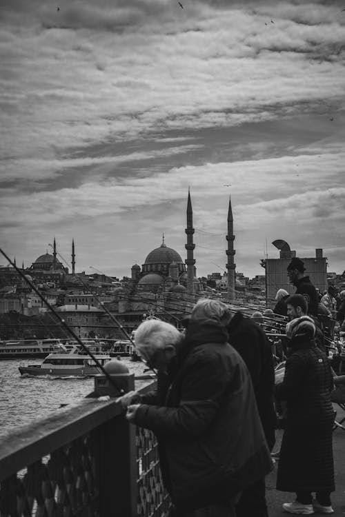 People on the bridge looking at the city