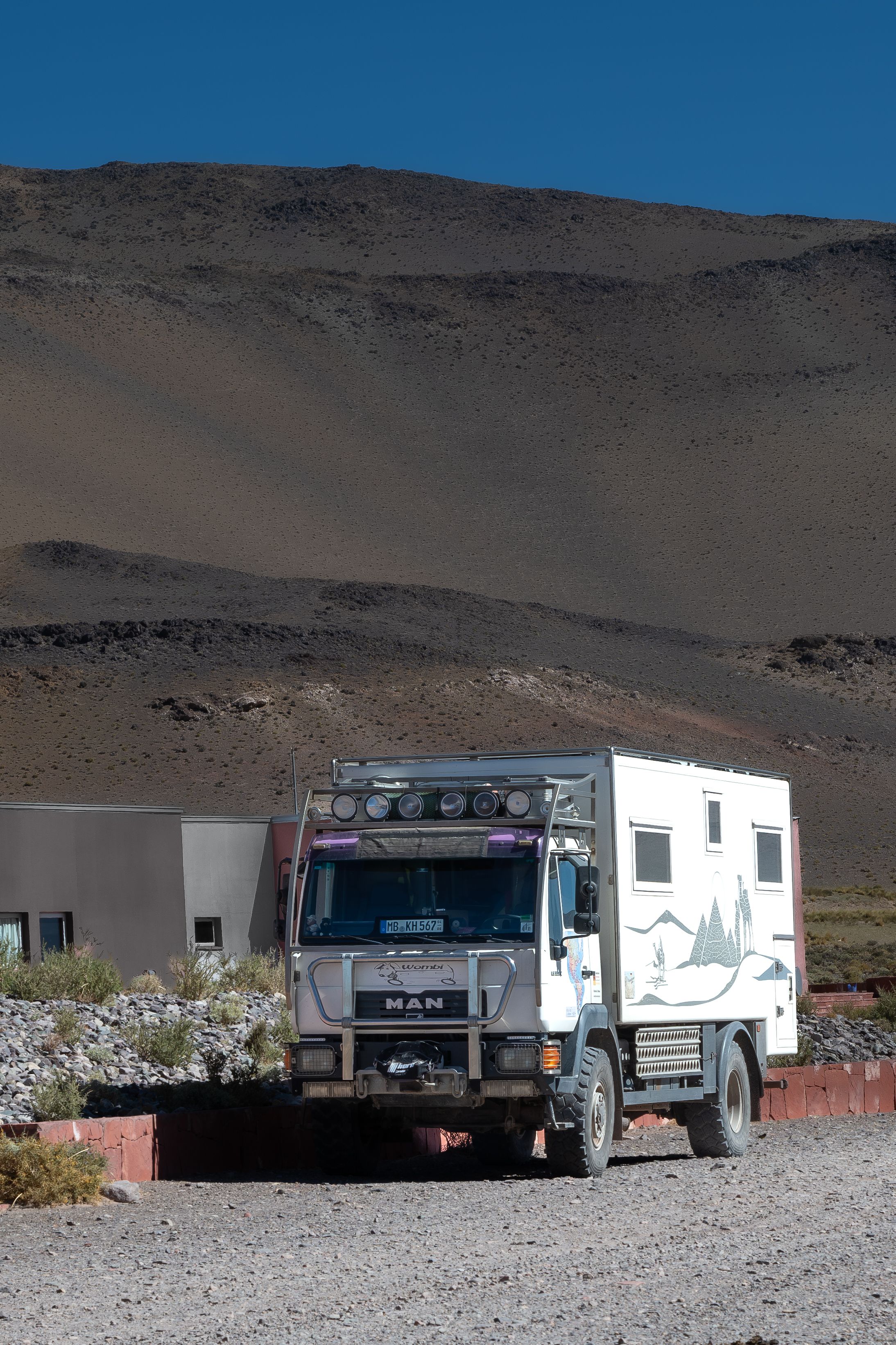 Expedition truck parked in the rugged rural landscape of Cortaderas, Catamarca, Argentina.