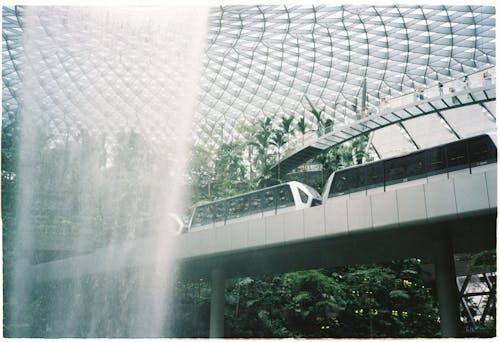 A fountain in a building with a large glass roof