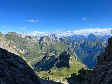 Breathtaking view of rugged alpine mountains with clear blue skies, showcasing nature's beauty.