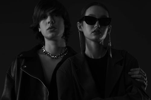 Two people in black and white, one with sunglasses