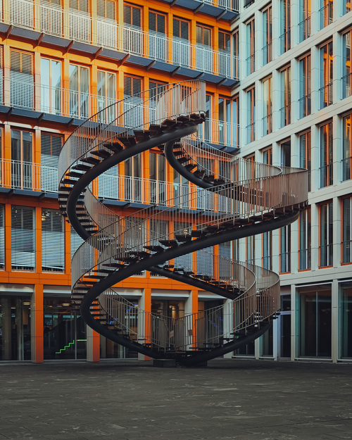 Free Spiral staircase sculpture in a modern Munich office building courtyard. Stock Photo