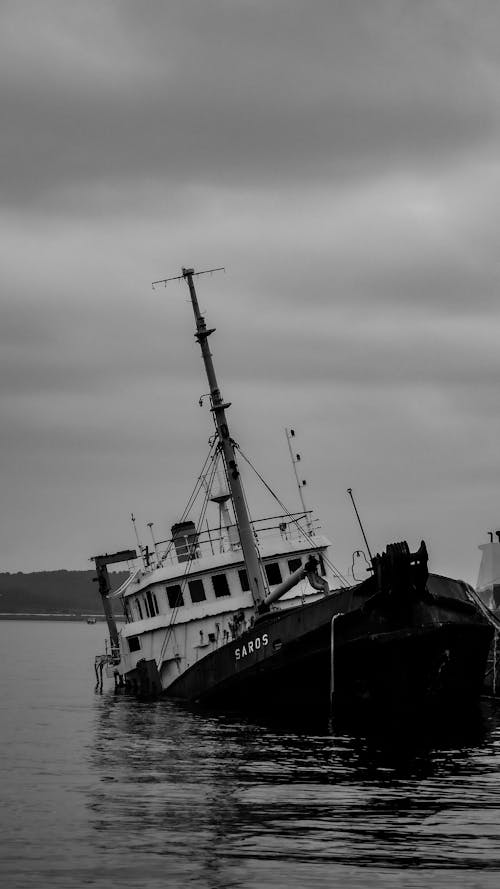 A black and white photo of a ship in the water