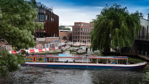 Blue and White Boat Crossing The River