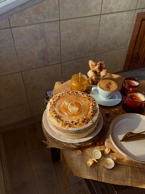 A Cake, a Candle and Cup of Coffee Standing on a Table